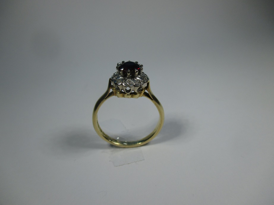 An 18ct gold diamond and garnet daisy ring, approx finger size O1/2