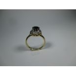 An 18ct gold diamond and garnet daisy ring, approx finger size O1/2