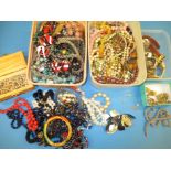 A large quantity of vintage costume jewellery to include a gold necklace