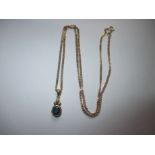 A 9ct gold necklace with a sapphire set pendant, approx weight 8.9g