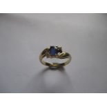 An 18ct yellow gold ring set with 4 diamonds and central blue sapphire, approx finger size 'S'