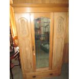 A waxed pine wardrobe with drawer to base