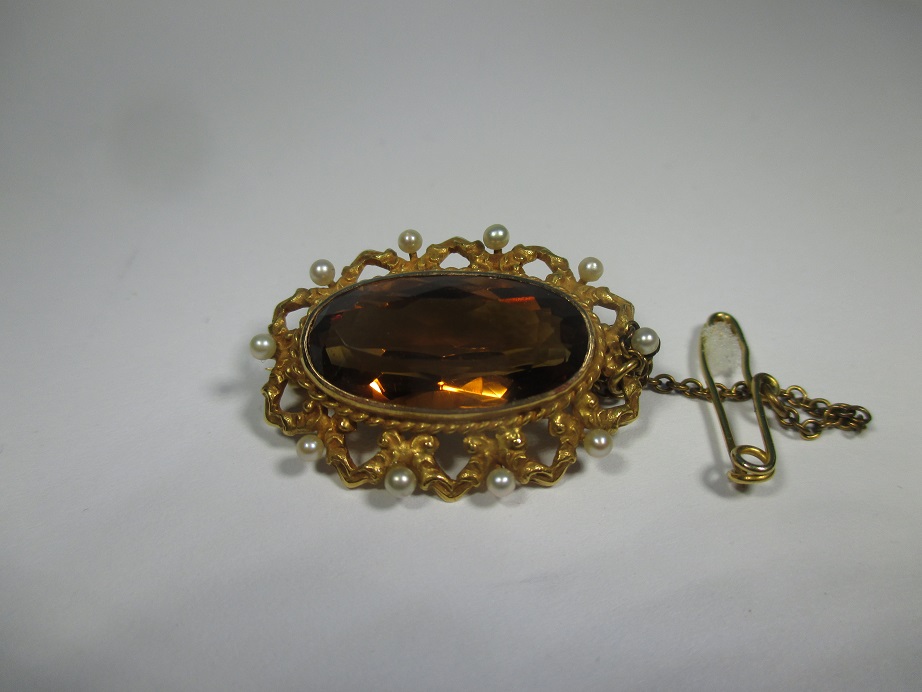 A 14ct gold brooch with large brown citrine and 10 seed peals