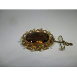 A 14ct gold brooch with large brown citrine and 10 seed peals