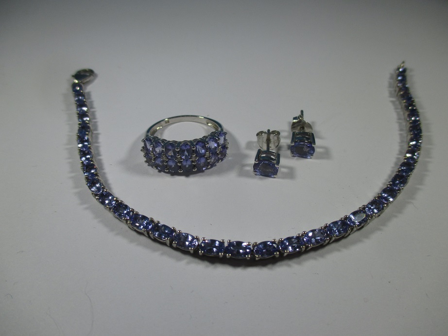 A silver and Tanzanite bracelet with matching ring and earrings