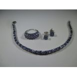 A silver and Tanzanite bracelet with matching ring and earrings