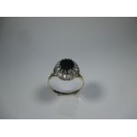 A 9ct gold diamond and dark blue sapphire cluster ring, approx finger size O