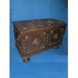 An antique oak storage chest of small proportions in the Jacobean style