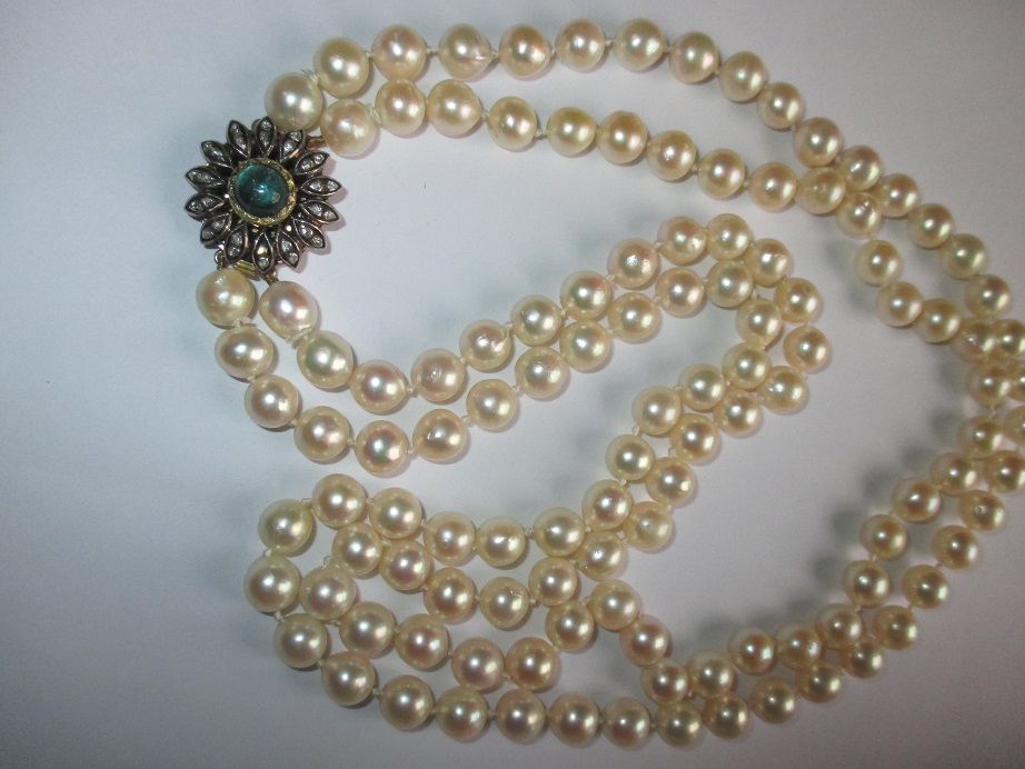 A 2 string pearl necklace with gem set gold and silver clasp