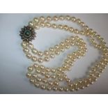 A 2 string pearl necklace with gem set gold and silver clasp