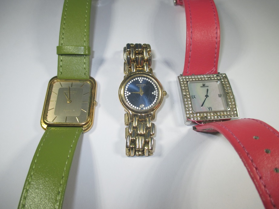 Two vintage Raymond Weil watches and a Swarovski example