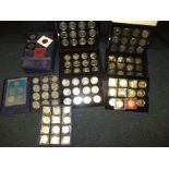 A quantity of commemorative crowns and coins in cases