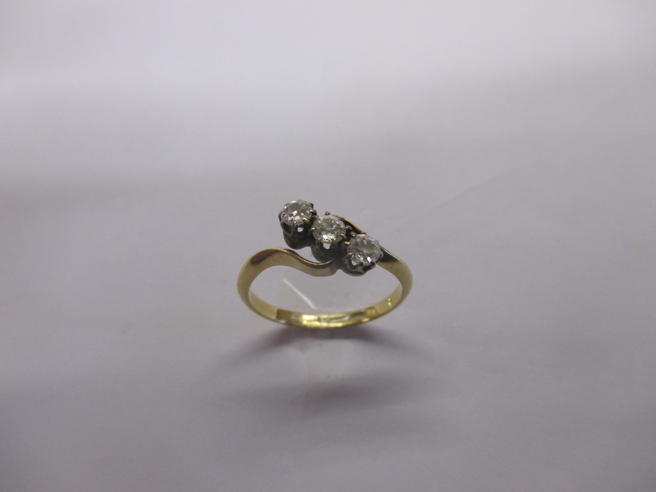 An antique gold ring set with 3 diamonds, approx finger size L