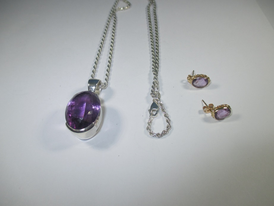 A pair of 585 gold and amethyst earrings and a silver necklace with a large amethyst pendant