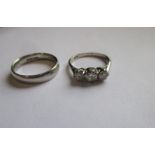 A platinum 3 stone diamond ring and a 950 platinum wedding band, approx finger size L