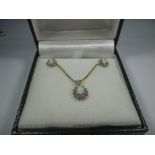 A 14k gold necklace earring set with diamonds and opals