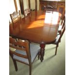 A mahogany extending dining table with 6 chairs