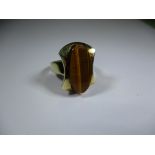 A 585 yellow gold ring set with a Tigers eye stone