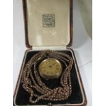 An antique fob watch with long neck chain