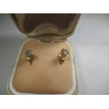 A pair of 9ct gold single diamond stud earrings