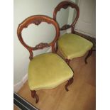 A pair of Victorian balloon back chairs with crisp carving