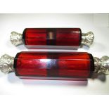 Two Victorian ruby glass double ended scent bottles with silver mounts.