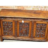 An antique coffer with profuse decorative carving