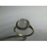 A 9ct gold dress ring with central cabochon Moonstone