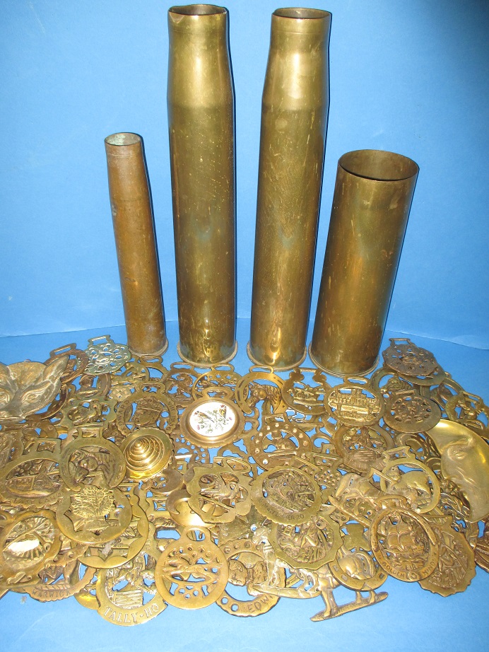 A large quantity of antique and later horse brasses and 4 shell cases