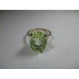 A 9ct yellow gold dress ring set with a large lime green stone