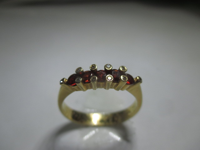 An 18ct yellow gold ring set with a central row of rubies flanked by 10 small diamonds. - Image 4 of 7