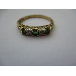 A 9ct gold ring set with diamonds and emeralds, approx. finger size O