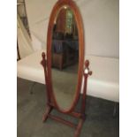 A vintage stained pine cheval mirror