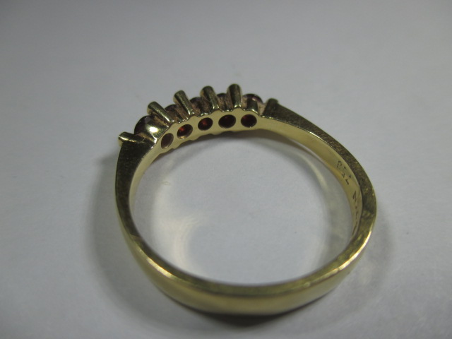 An 18ct yellow gold ring set with a central row of rubies flanked by 10 small diamonds. - Image 2 of 7