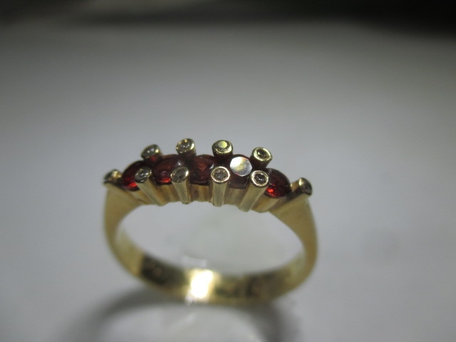 An 18ct yellow gold ring set with a central row of rubies flanked by 10 small diamonds. - Image 3 of 7