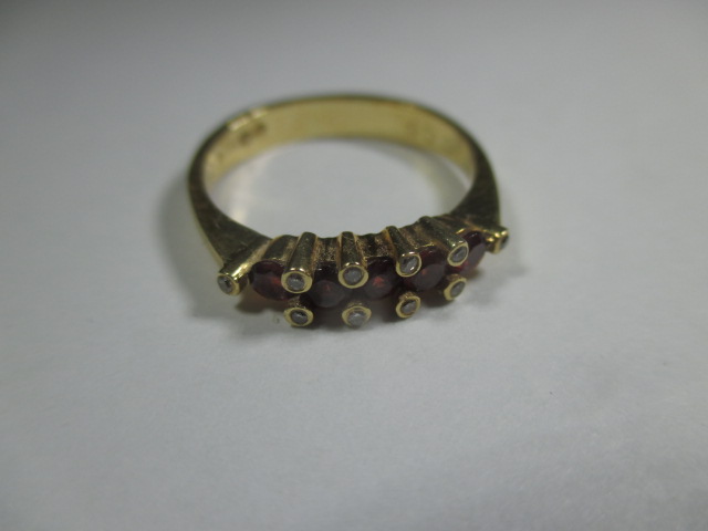 An 18ct yellow gold ring set with a central row of rubies flanked by 10 small diamonds. - Image 5 of 7