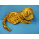 An early 20th century plush tiger, approx. length nose to haunch 31cm.