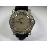 A vintage ladies Omega platinum wristwatch with diamond set bezel.