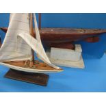 A very early 20th century model sailing yacht and a smaller later model