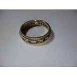 A 9ct gold eternity ring set with alternating coloured stones, approx finger size M