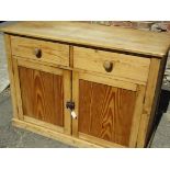 An early 20th century waxed pine kitchen cupboard