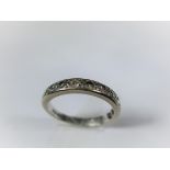 An 18ct gold half eternity ring set will 11 diamonds