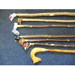 A quantity of modern hand-carved walking sticks