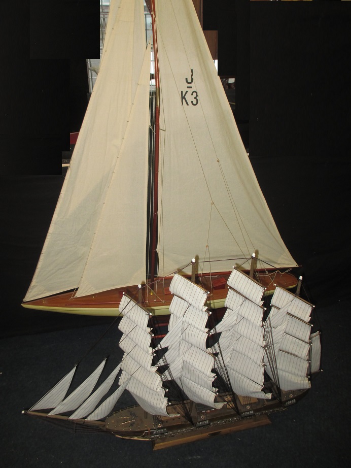 A large model sailing yacht and one other