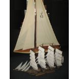 A large model sailing yacht and one other