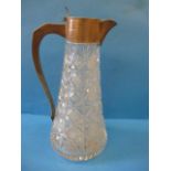 A lead crystal claret jug with silver mount