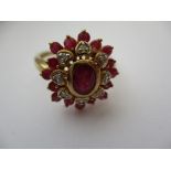 A 9ct yellow gold diamond and ruby? daisy cluster ring, approx. ring size P1/2.
