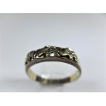 A vintage 9ct gold ring having 3 stylised elephants to crown