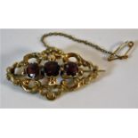 A yellow metal antique brooch set with garnets 6g