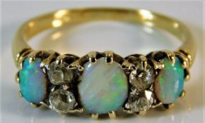An 18ct gold ring set with opal & diamond 2.6g siz